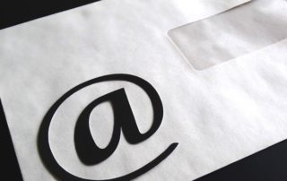 Email "at" on plain white envelope