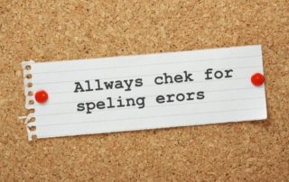bulletin board with note about checking for spelling errors