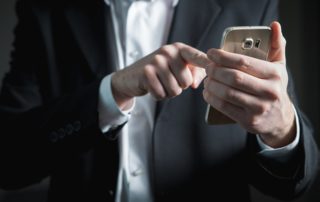 finger poised to send an email on mobile phone