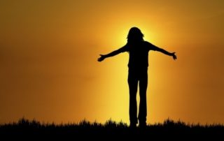 woman with arms outstretched in gratitude