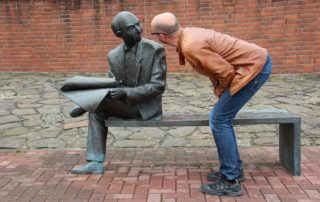 man talking to sculpture man