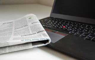 newspaper with computer