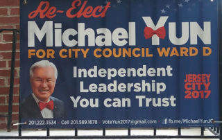 Re-elect council member sign has red tie on his photo and on his name