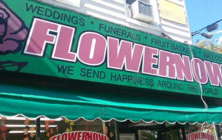 FlowerNow shop sign has a great tagline: "We send happiness around the world."