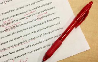 editing grammar on paper with a red pen