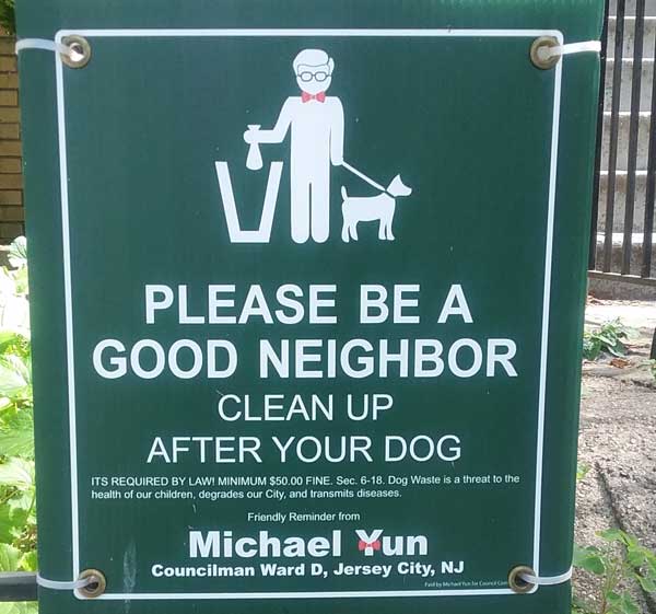 Sign that says Please be a good neighbor. Clean up after your dog.