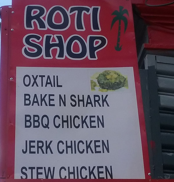Sign from a roti shop including the phrase "bake n shark"