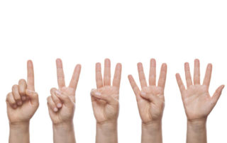 photo of five hands holding up fingers one to five