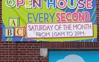 Photo of a sign for a day care center that says "Open house every second" and then in smaller print "Saturday of the month"