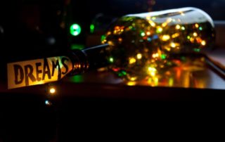 Photo of a bottle filled with colored lights, against a dark background