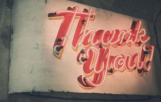 photo of a neon sign that says Thank you